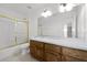 Bathroom featuring white tile, a large mirror, and a tub/shower combination at 4071 Albritton Rd, St Cloud, FL 34772