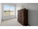 Bright bedroom with a wooden dresser, a decorative ship, and a large window with a view at 4071 Albritton Rd, St Cloud, FL 34772