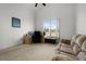 Bedroom featuring a large window, sofa, and desk with computer monitors at 4071 Albritton Rd, St Cloud, FL 34772