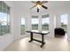 Light-filled dining area with large windows and a rustic wood table at 4071 Albritton Rd, St Cloud, FL 34772