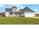 Side view of a two-story house featuring a turret and a two-car garage at 4071 Albritton Rd, St Cloud, FL 34772