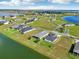 Aerial view of a lakefront community with multiple homes and green spaces at 473 Adams View Ln, Auburndale, FL 33823