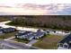 Aerial view of a luxury home on a waterfront lot at sunset at 473 Adams View Ln, Auburndale, FL 33823