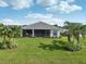 Home features a large screened lanai and lush landscaping at 473 Adams View Ln, Auburndale, FL 33823