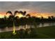 Tranquil evening view of canal and palm trees at 473 Adams View Ln, Auburndale, FL 33823