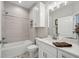 Modern bathroom with white vanity, bathtub, and updated tile at 473 Adams View Ln, Auburndale, FL 33823