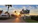 Gated entrance to a waterfront community at sunset at 473 Adams View Ln, Auburndale, FL 33823