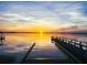 Stunning sunset over the lake with a dock at 473 Adams View Ln, Auburndale, FL 33823