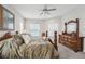 Main bedroom features a king bed, dresser, and ceiling fan at 473 Adams View Ln, Auburndale, FL 33823