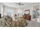 Spacious main bedroom with a king-size bed, dresser, and ceiling fan at 473 Adams View Ln, Auburndale, FL 33823