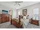 Main bedroom with king bed, dresser and ensuite bathroom access at 473 Adams View Ln, Auburndale, FL 33823