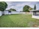 Spacious backyard featuring a shed, swing set, white fence, and screened-in patio at 105 Elliott Ln, Winter Haven, FL 33884