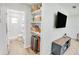 Hallway with open shelving leading to the bathroom with white tile and glass enclosed shower at 105 Elliott Ln, Winter Haven, FL 33884