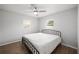 Neutral bedroom showcases hardwood floors, ceiling fan, and plenty of natural light through two windows at 105 Elliott Ln, Winter Haven, FL 33884