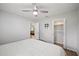 Bedroom with a ceiling fan, closet, and views into the living room of this home at 105 Elliott Ln, Winter Haven, FL 33884