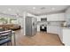 Inviting kitchen featuring stainless steel appliances, white cabinets and modern fixtures at 105 Elliott Ln, Winter Haven, FL 33884