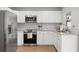 Modern kitchen with stainless steel appliances, white cabinets, and granite countertops at 105 Elliott Ln, Winter Haven, FL 33884