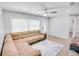 Welcoming living room with L-shaped couch, modern ceiling fan, and bright natural light at 105 Elliott Ln, Winter Haven, FL 33884