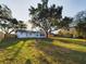 Expansive backyard featuring mature trees and a wooden fence at 2002 Sutton Rd, Lakeland, FL 33810