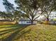 View of the backyard featuring mature trees and partial fencing at 2002 Sutton Rd, Lakeland, FL 33810