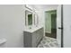 Bathroom featuring a double vanity with modern mirrors and lighting, as well as patterned tile floors at 2002 Sutton Rd, Lakeland, FL 33810