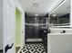 Stylish bathroom showcasing a glass-enclosed shower and a black double vanity with modern gold vessel sinks at 2002 Sutton Rd, Lakeland, FL 33810