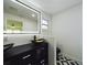 Bright bathroom with modern lighting, a dual vanity with gold vessel sinks, and stylish geometric-patterned floors at 2002 Sutton Rd, Lakeland, FL 33810