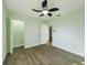 Light-filled bedroom featuring wood-look flooring, fresh paint, white trim, and an open closet at 2002 Sutton Rd, Lakeland, FL 33810