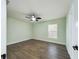 Inviting bedroom featuring modern ceiling fan, wood-look flooring, and natural light from the window at 2002 Sutton Rd, Lakeland, FL 33810