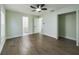 Bright bedroom featuring modern ceiling fan, wood-look flooring, and an ensuite bathroom at 2002 Sutton Rd, Lakeland, FL 33810