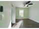 Bright bedroom with light green walls, wood-look flooring, a ceiling fan, and natural light from the window at 2002 Sutton Rd, Lakeland, FL 33810