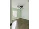 Bedroom with a modern ceiling fan, light green walls, wood-look floors, and a sunlit window at 2002 Sutton Rd, Lakeland, FL 33810