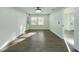 Bright bedroom with light green walls, wood-look floors, and two windows at 2002 Sutton Rd, Lakeland, FL 33810