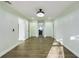 Spacious bedroom featuring modern lighting, light green walls, and wood-look flooring at 2002 Sutton Rd, Lakeland, FL 33810