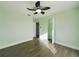 Bright bedroom featuring modern ceiling fan, wood-look flooring, fresh paint, and natural light from the window at 2002 Sutton Rd, Lakeland, FL 33810