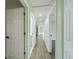 Hallway with hard wood floors and access to multiple rooms at 2002 Sutton Rd, Lakeland, FL 33810