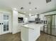 Modern white kitchen featuring stainless steel appliances, quartz countertops, and a tiled backsplash at 2002 Sutton Rd, Lakeland, FL 33810