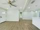 Bright, open living room with light green walls, modern lighting, and wood-look floors at 2002 Sutton Rd, Lakeland, FL 33810