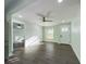 Living room featuring wood-look flooring, light green walls, and an open doorway at 2002 Sutton Rd, Lakeland, FL 33810