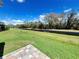 Backyard with well maintained grass and canal views at 222 Cattail Way, Lake Alfred, FL 33850