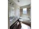 Bright bathroom offering a vanity and a tiled shower and tub at 222 Cattail Way, Lake Alfred, FL 33850