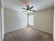 Carpeted bedroom featuring a ceiling fan and bright window at 222 Cattail Way, Lake Alfred, FL 33850