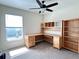 Bedroom with a ceiling fan, large window, and wooden furniture at 222 Cattail Way, Lake Alfred, FL 33850