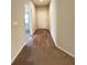 Bright hallway with light-colored walls, wood-look flooring, and carpet at 222 Cattail Way, Lake Alfred, FL 33850