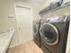 Well-equipped laundry room with modern washer, dryer, and ample storage at 222 Cattail Way, Lake Alfred, FL 33850