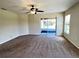 Bright living room with sliding glass doors and neutral paint color at 222 Cattail Way, Lake Alfred, FL 33850