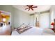 Relaxing bedroom with ceiling fan, access to bathroom, and a view of another room at 235 Foggy Creek Rd, Davenport, FL 33837