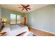 Spacious bedroom with large window, ceiling fan, and ample natural light at 235 Foggy Creek Rd, Davenport, FL 33837