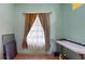 Small bedroom with window and wood floors at 235 Foggy Creek Rd, Davenport, FL 33837