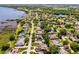 A residential neighborhood is seen from an aerial view; houses are surrounded by trees and one is highlighted with a marker at 324 Hamilton Shores Ne Dr, Winter Haven, FL 33881